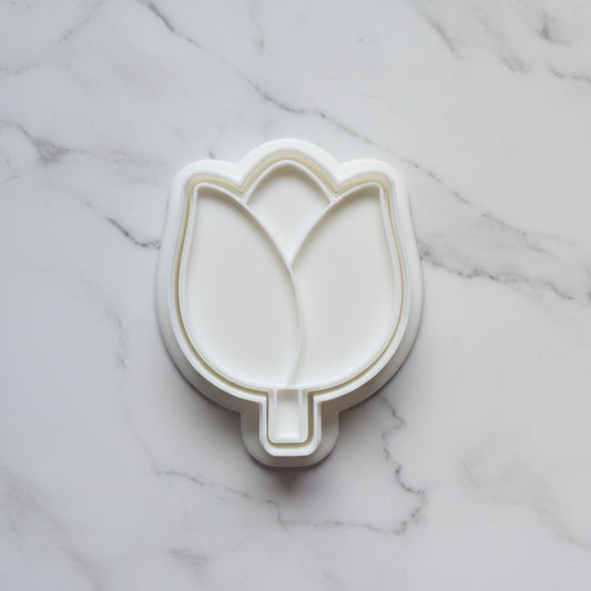 Tulip Cookie Cutter and Stamp on white marble backround