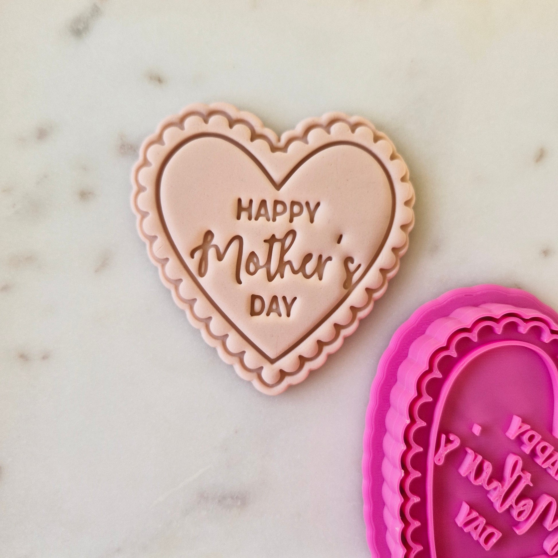 Happy Mother's Day Heart Cookie Cutter and Stamp zoomed out on white marble stone